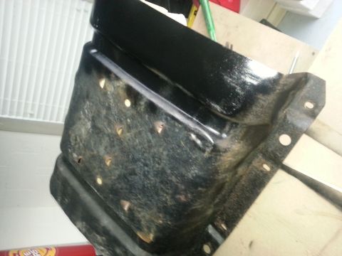 1994 Ford Bronco - This is a metal bracket with many holes, possibly for mounting.