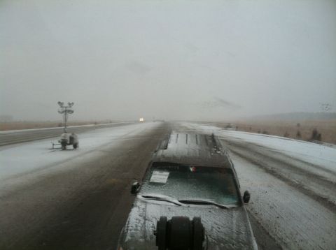 2011 Volvo V90 - SUV driving on a snowy road with a portable light tower visible.
