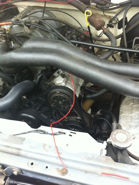 1990 Ford F-150 - Close-up view of a vehicle's engine compartment, showing various mechanical parts and wiring.
