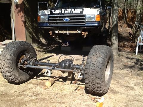 1989 Ford Bronco - This Ford truck appears to be undergoing modifications with its front end lifted and suspension components exposed.