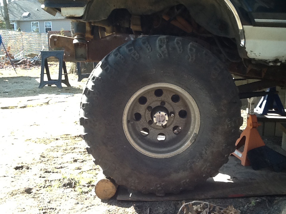 Side view of a 1989 Ford Bronco's large off-road tire and suspension