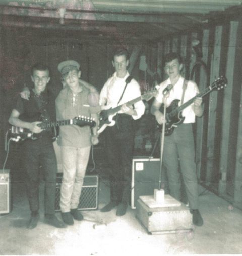 1963 Ford Galaxie - A group of musicians with electric guitars and amplifiers in a dimly lit room.