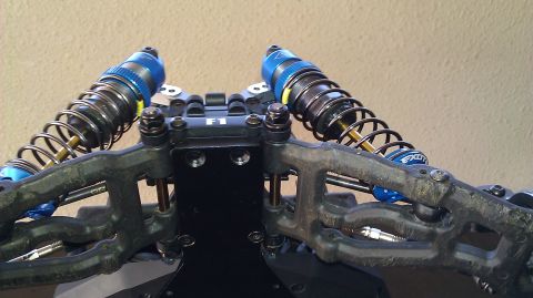 1996 Ford Bronco - Close-up of RC car suspension components, including shock absorbers and control arms.