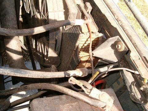 1991 Ford Bronco - Close-up view of the engine bay, showing a damaged radiator and various hoses.