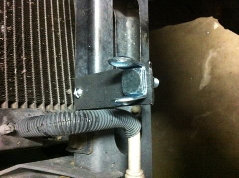 2005 Dodge 1500 - Close-up view of a vehicle's radiator with a custom-mounted bracket and hardware.