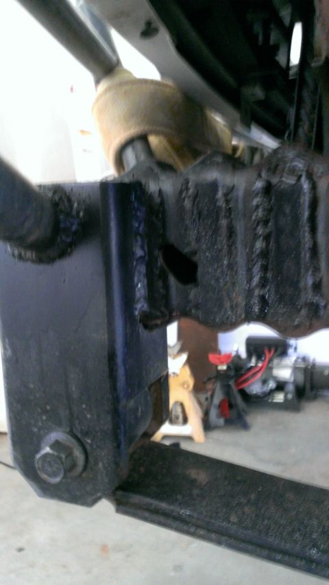 1994 Ford Bronco - A close-up view of a vehicle's suspension system, focusing on a leaf spring and associated components.