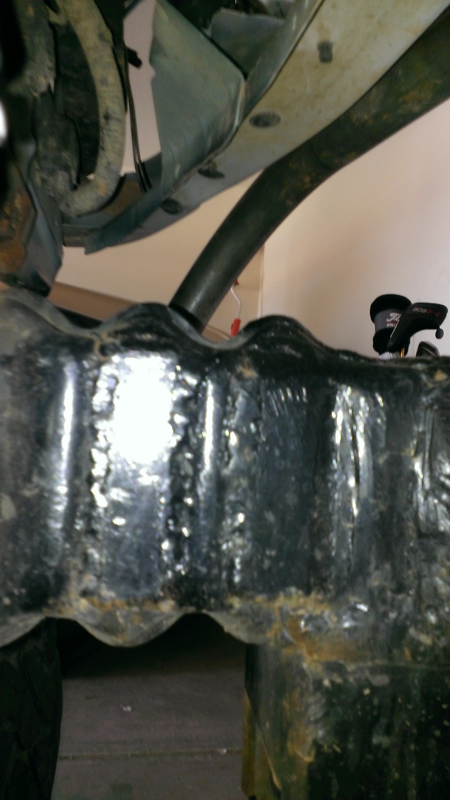 Underside of a vehicle showing frame and suspension components. SuperMotors.net logo visible