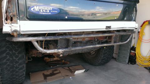 1994 Ford Bronco - Custom rear bumper and large tire visible on a truck, with a 'Midnight 4x4' sticker on the body.
