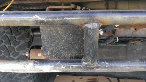 1994 Ford Bronco - This photo shows the undercarriage of a vehicle, focusing on a robust aftermarket bumper and suspension parts.
