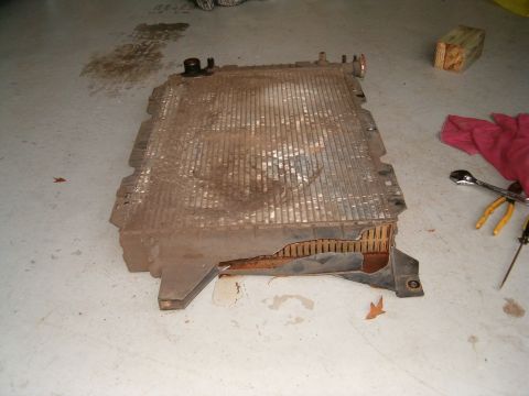 1991 Ford Bronco - Radiator removed from a vehicle, showing damage to the fins and side.