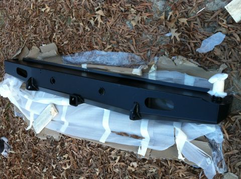 1992 Ford C-350 (Centurion Conversions) - New aftermarket bumper for a truck, packaged for shipping and resting on the ground.