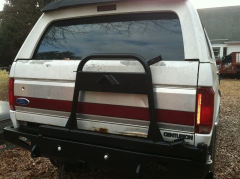 1992 Ford C-350 (Centurion Conversions) - The rear of a white Ford Bronco Centurion Conversion shows a custom bumper and spare tire mount.