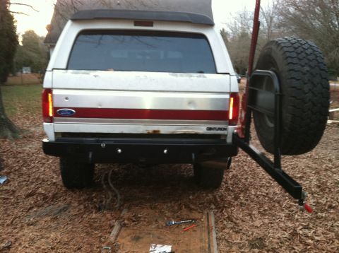 1992 Ford C-350 (Centurion Conversions) - Rear view of a white Ford Bronco Centurion, showing its external spare tire mount and taillights.