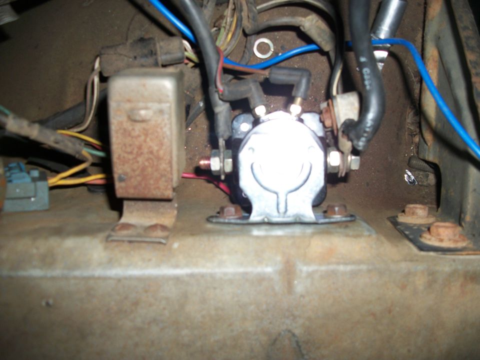 Starter solenoid and wiring harness in a vehicle's engine bay