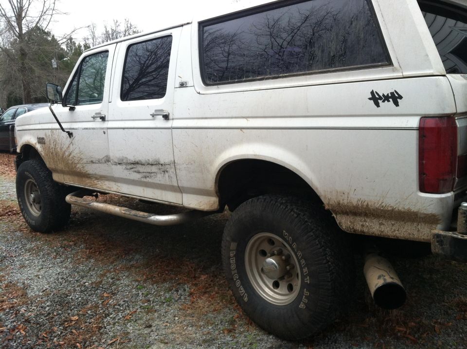 White 1992 Ford C-350 Centurion Conversions SUV, side view, muddy body, off-road tires, side steps