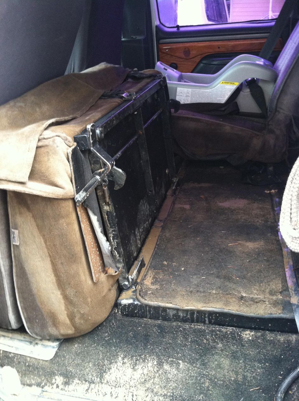 Interior of a van with a folded seat and a car seat