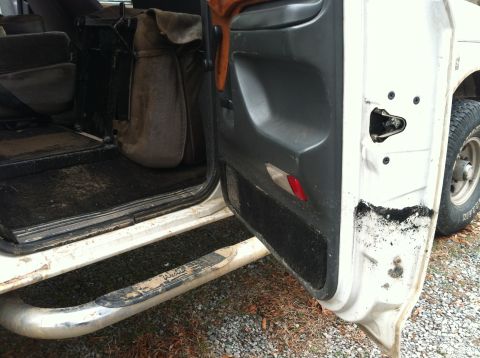 1992 Ford C-350 (Centurion Conversions) - Interior view of a truck's open door, revealing the driver's side floor and door panel.