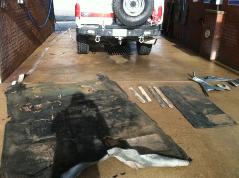 1992 Ford C-350 (Centurion Conversions) - The rear of a 1992 Ford C-350 (Centurion Conversions) truck is shown, with interior components removed and laid out on the floor.