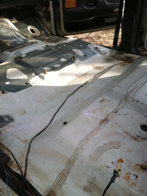 1992 Ford C-350 (Centurion Conversions) - The interior floor of a vehicle, stripped down and showing signs of wear and tear.