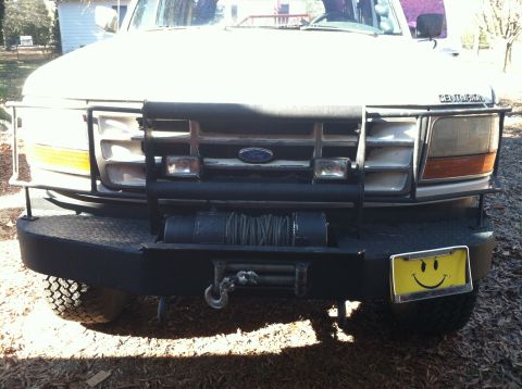 1992 Ford C-350 (Centurion Conversions) - This Ford truck features a heavy-duty bumper, brush guard, and a winch, along with a playful smiley face license plate.