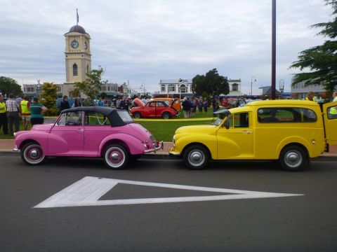 1969 MINI Cooper - Two classic Morris Minor vehicles, a convertible and a Traveller van, are displayed at an outdoor event.