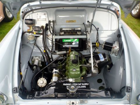 1969 MINI Cooper - Close-up view of a car's engine bay, showing the engine, battery, and associated components.