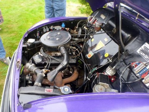 1969 MINI Cooper - The engine bay of a purple 1969 MINI Cooper is open for viewing.