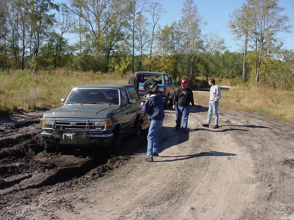 Gray 1991 Ford Bronco stuck in mud, front view