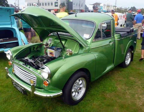 1969 MINI Cooper - A classic green pickup truck is displayed with its hood open, revealing the engine bay.