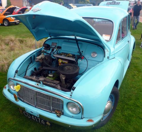 1969 MINI Cooper - A light blue 1959 Morris Minor 1000 is displayed with its hood open, revealing the engine bay.