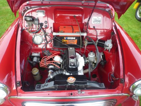 1969 MINI Cooper - Engine bay of a classic red 1969 MINI Cooper, showing the engine and battery.
