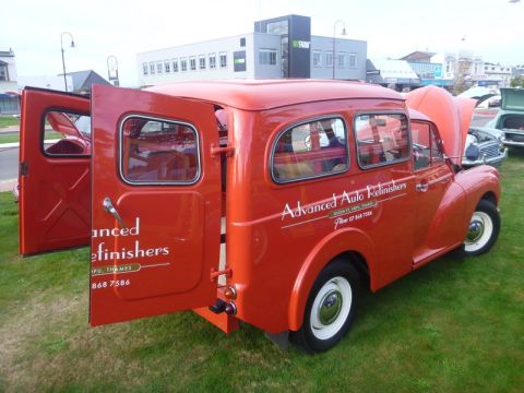 1969 MINI Cooper - This red van, possibly a Morris Minor Traveller, is displayed with its doors open, revealing its interior and advertising 'Advanced Auto Re…