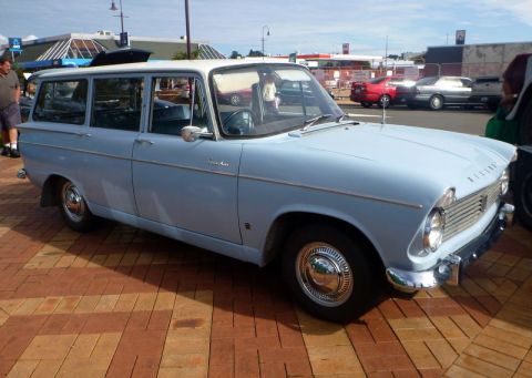 1969 MINI Cooper - A light blue station wagon with a white roof is parked on a brick-patterned surface.