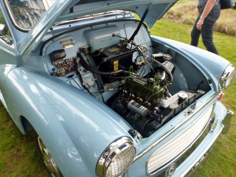 1969 MINI Cooper - Close-up of the engine bay of a vintage car, with the hood raised to reveal the engine components.