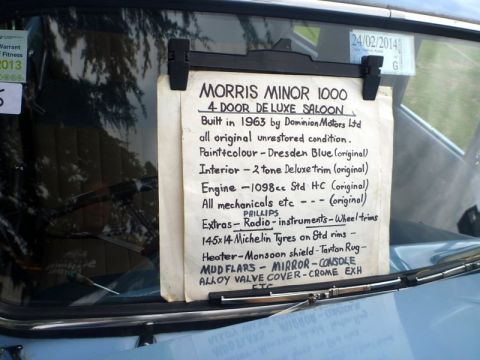1969 MINI Cooper - A sign inside a car details its specifications, including its build year of 1963 and model name.