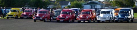 1969 MINI Cooper - A collection of classic Morris Mini vans and pickups are lined up, their distinctive designs.