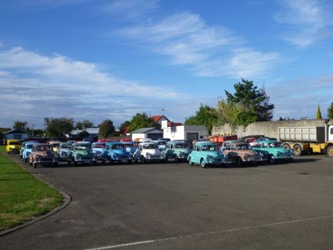 1969 MINI Cooper - A group of classic MINI Coopers are parked together in an outdoor lot.