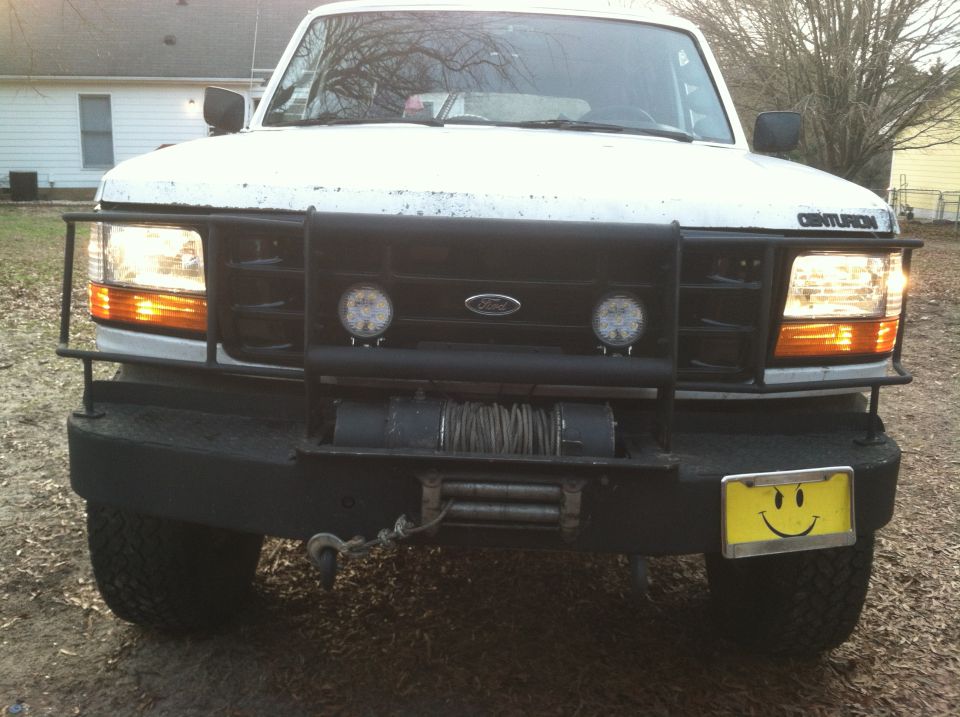 White 1992 Ford C-350 (Centurion Conversions) front view with winch and brush guard