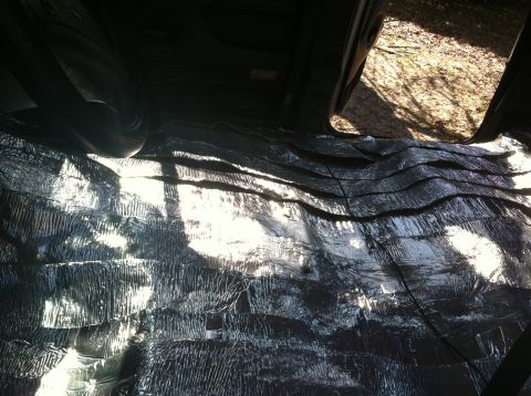 1992 Ford C-350 (Centurion Conversions) - Soundproofing material is installed on the floor and lower walls of a vehicle's interior.