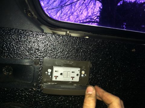 1992 Ford C-350 (Centurion Conversions) - Vehicle interior shows an electrical outlet and a window with a view of trees.