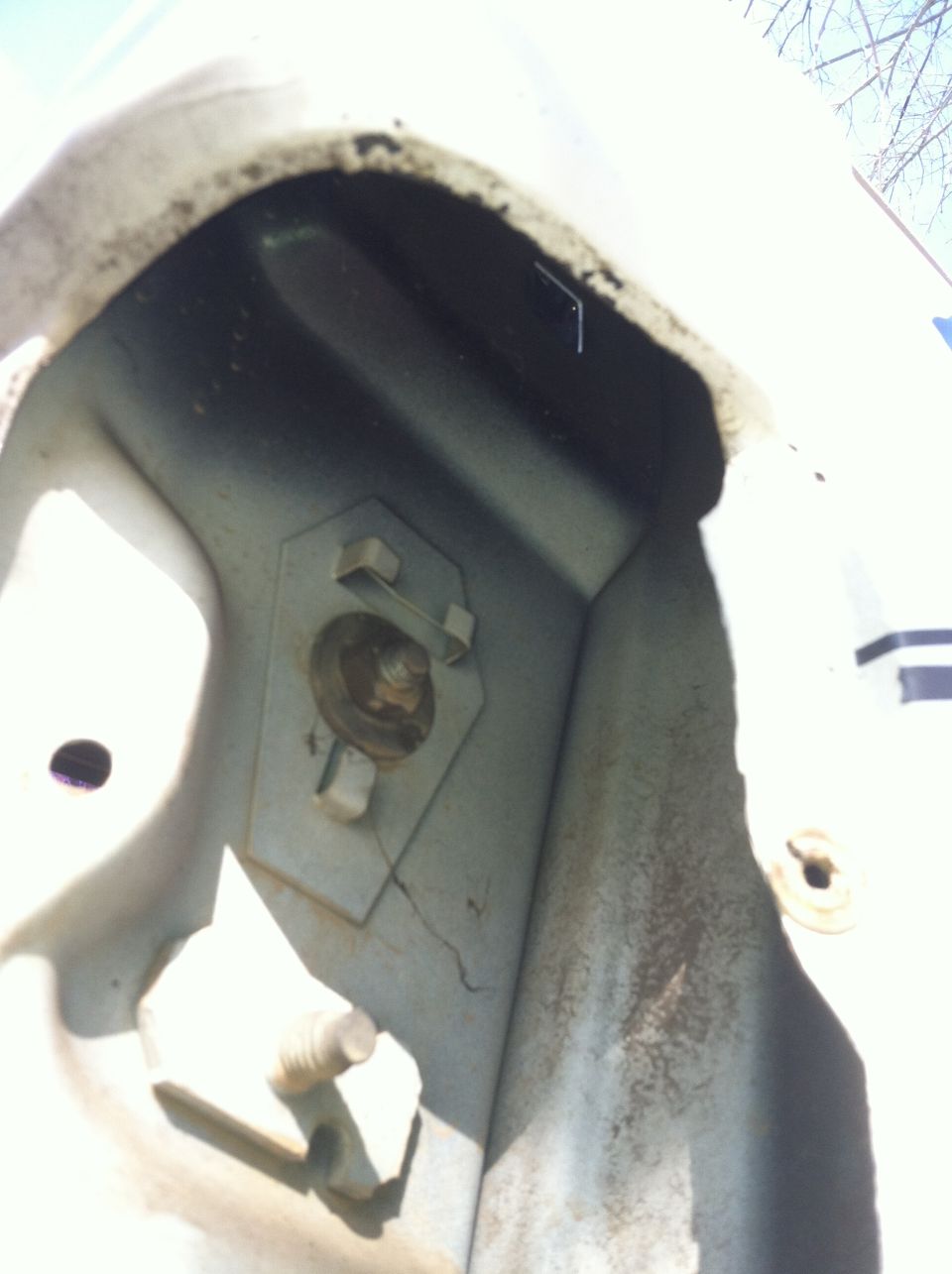 Close-up of a rusty metal bracket with a bolt