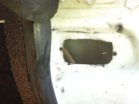 1992 Ford C-350 (Centurion Conversions) - Interior view of a vehicle's floor showing a cut-out section and surrounding material.
