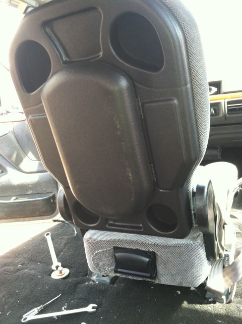 1992 Ford C-350 (Centurion Conversions) - Interior view of a vehicle seat, with tools visible on the floor during what appears to be a repair or modification.