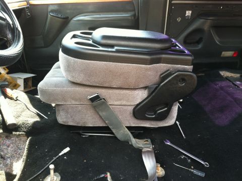 1992 Ford C-350 (Centurion Conversions) - The interior of a vehicle is shown with the seats removed, revealing the floor and center console area.