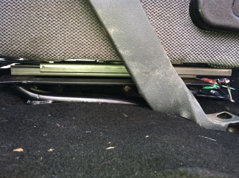 1992 Ford C-350 (Centurion Conversions) - Interior view of seat mounting hardware and carpet, with visible wiring.