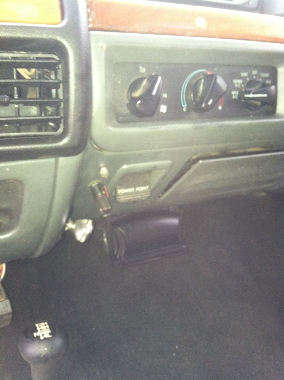 Ford truck dash with three-knob HVAC controls, POWER POINT outlet and floor shifter