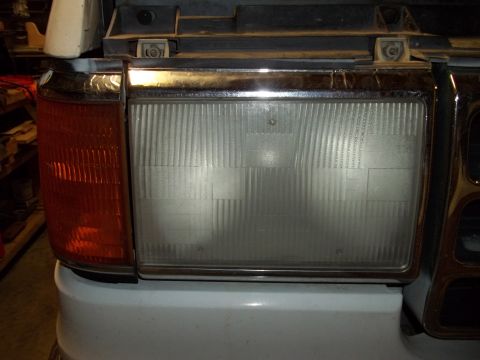 1990 Ford Bronco - The headlight and amber turn signal assembly of a 1992 Ford Bronco is shown in this close-up view.