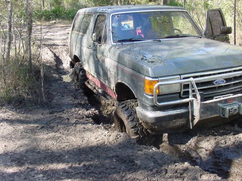 1991 Ford Bronco - This Ford Bronco is stuck in the mud on a wooded trail.