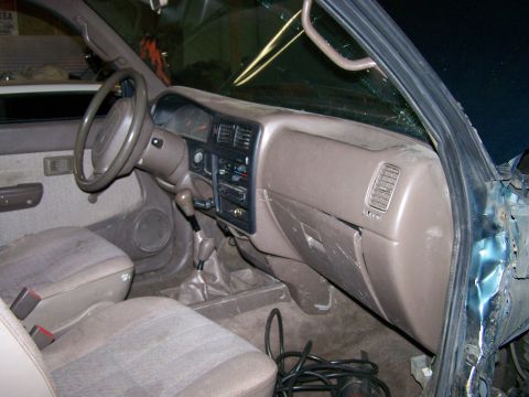 1988 Suzuki Samurai - Interior of a pickup truck, likely from the early 1990s, with a manual transmission.