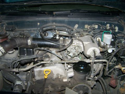 1988 Suzuki Samurai - Close-up view of an engine bay, showing various components and wiring.